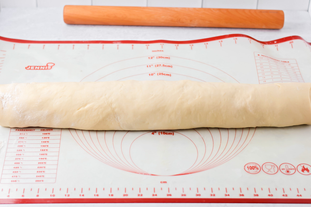 Cinnamon roll Dough filled and rolled up.