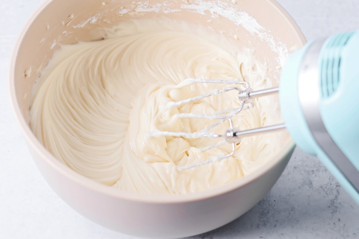 Cream cheese frosting mixed together in bowl.