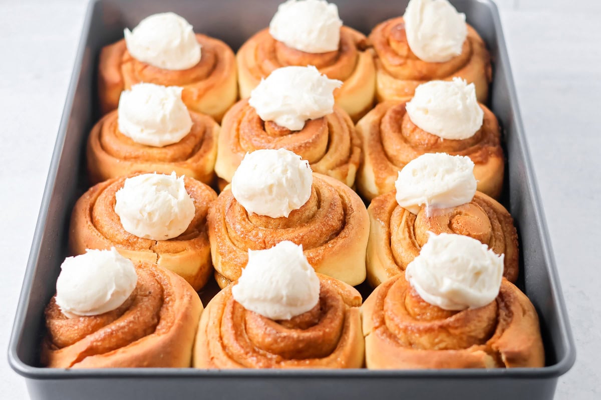 Cream cheese frosting on cinnamon rolls.