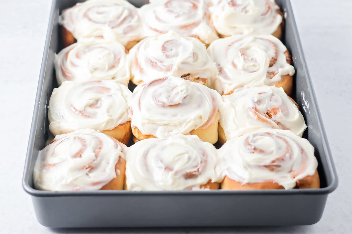 Easy cinnamon rolls baked and frosted in baking dish.