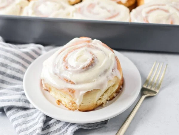 Easy cinnamon roll cut and put on white plate.