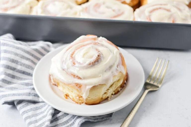 Easy cinnamon roll cut and put on white plate.