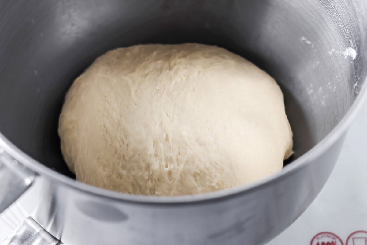 Cinnamon roll dough in mixing bowl.