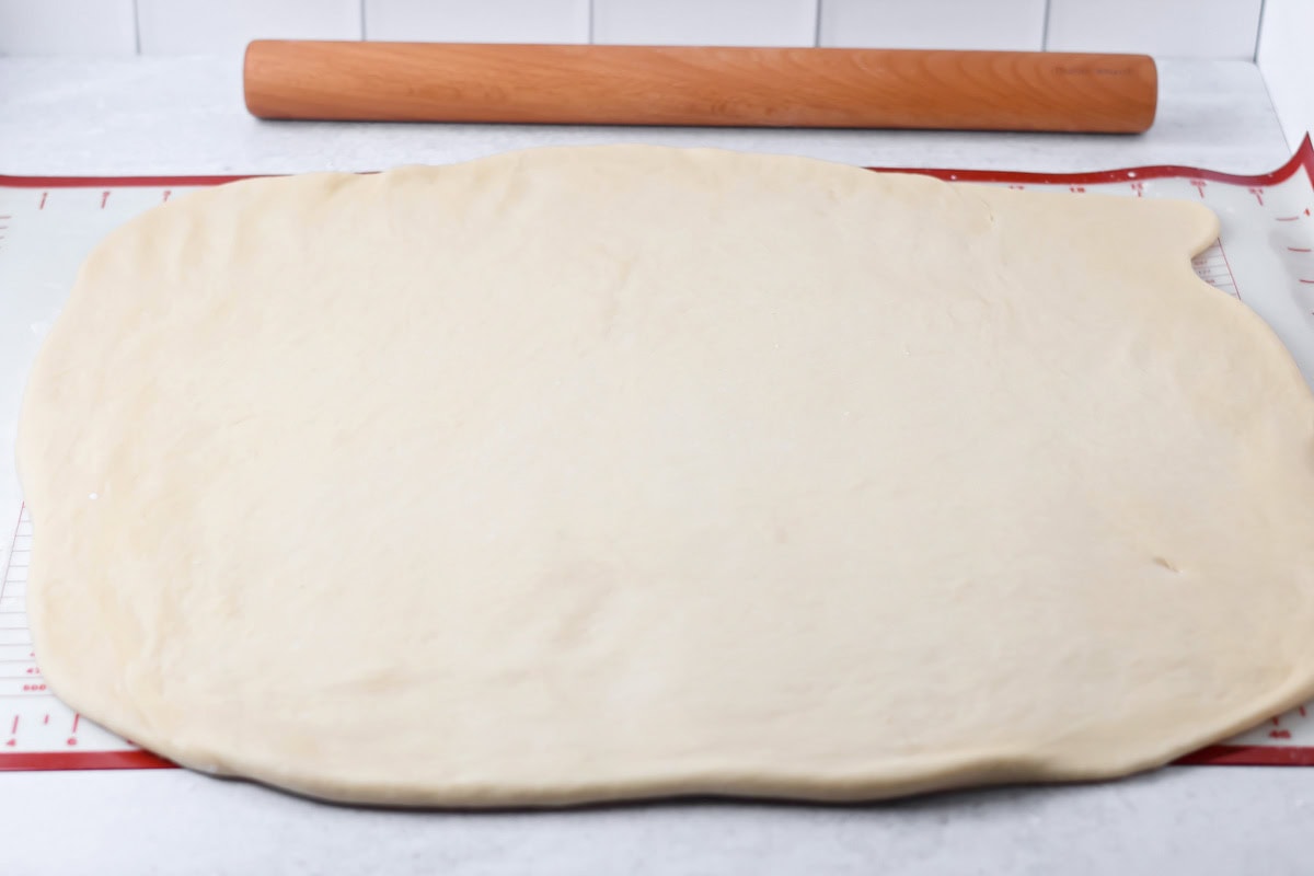 Cinnamon roll dough rolled out.