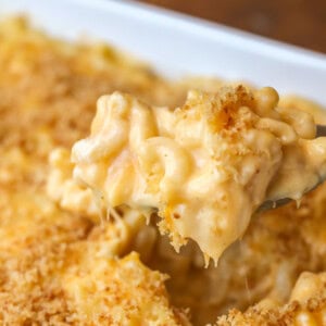 Homemade mac and cheese recipe being scooped out of dish.