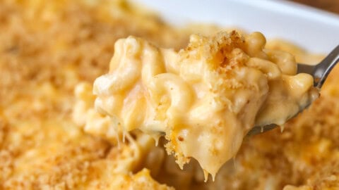 Homemade mac and cheese recipe being scooped out of dish.