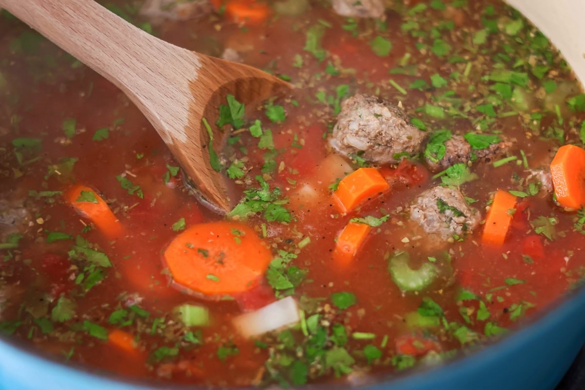 Ingredients for albondigas in pot.