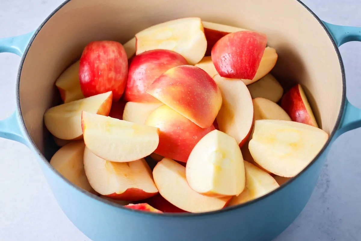 Apples in pot being ready to make apple cider.