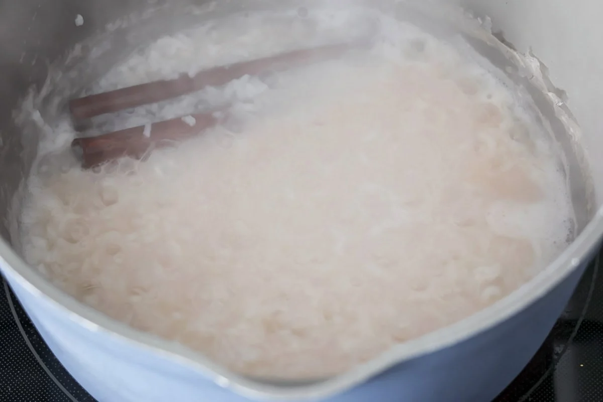 Rice and water boiling in a pan.