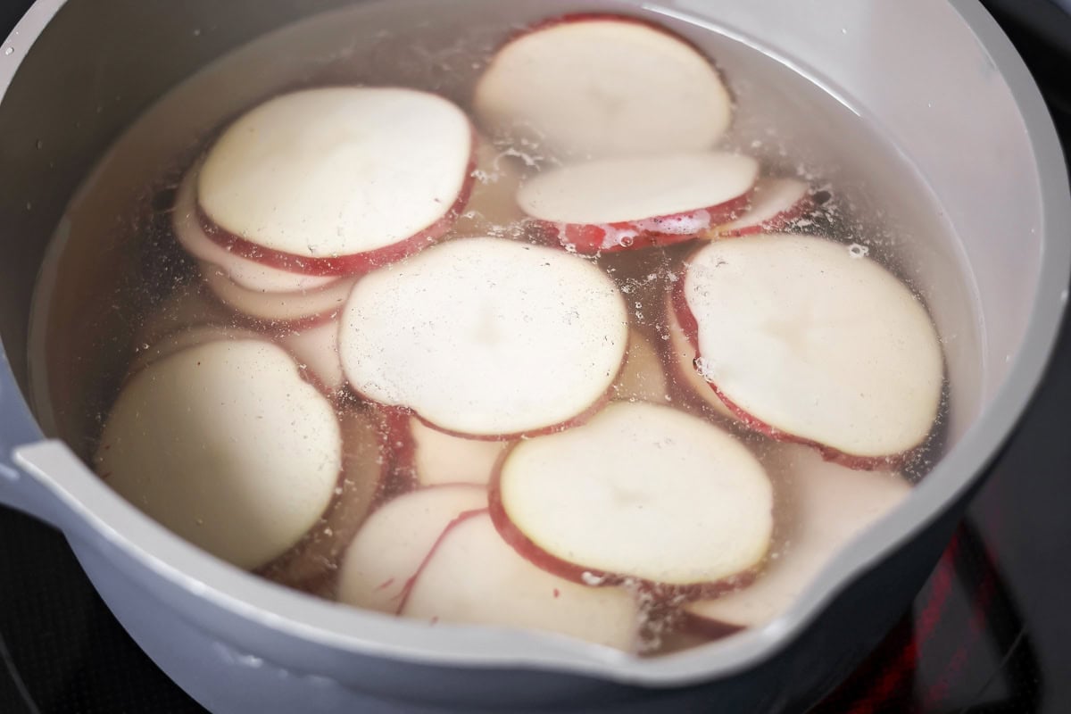 Potatoes being par-boiled in pot with water.
