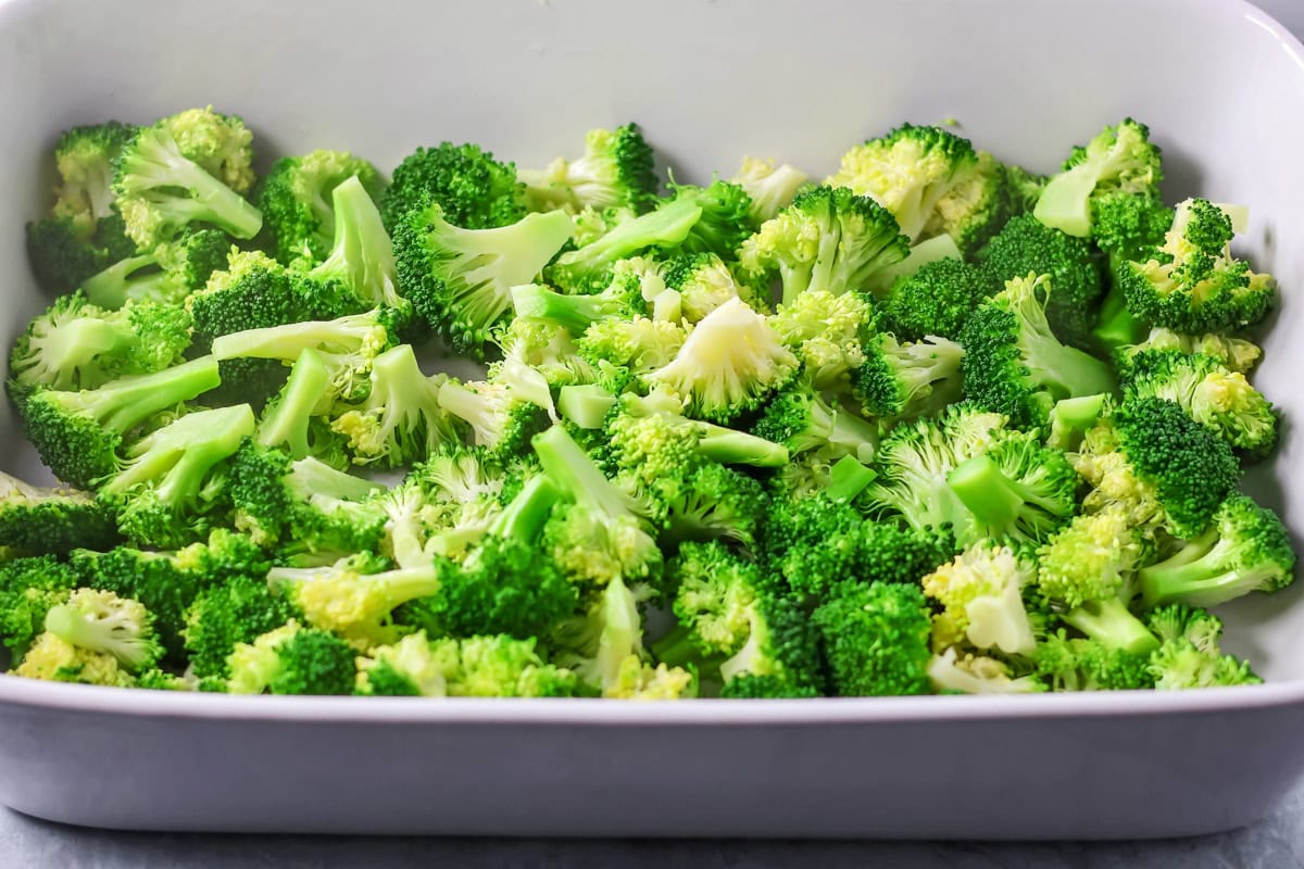 Broccoli at the bottom of a casserole dish.