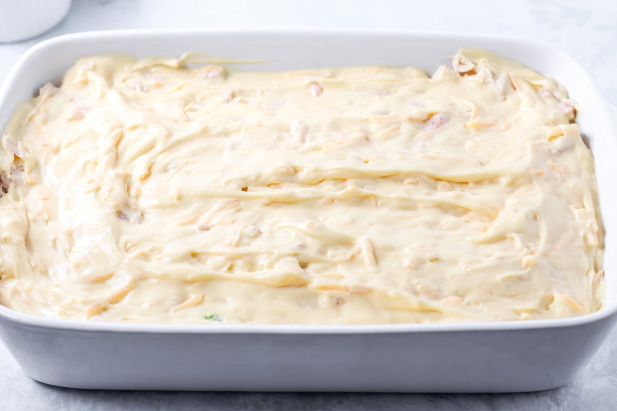 Cream of chicken soup poured over casserole in dish.