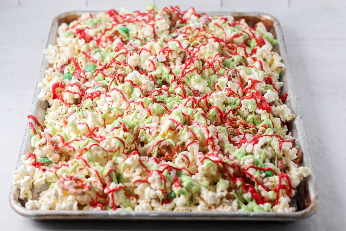 Candy coating drizzled over homemade Christmas popcorn.