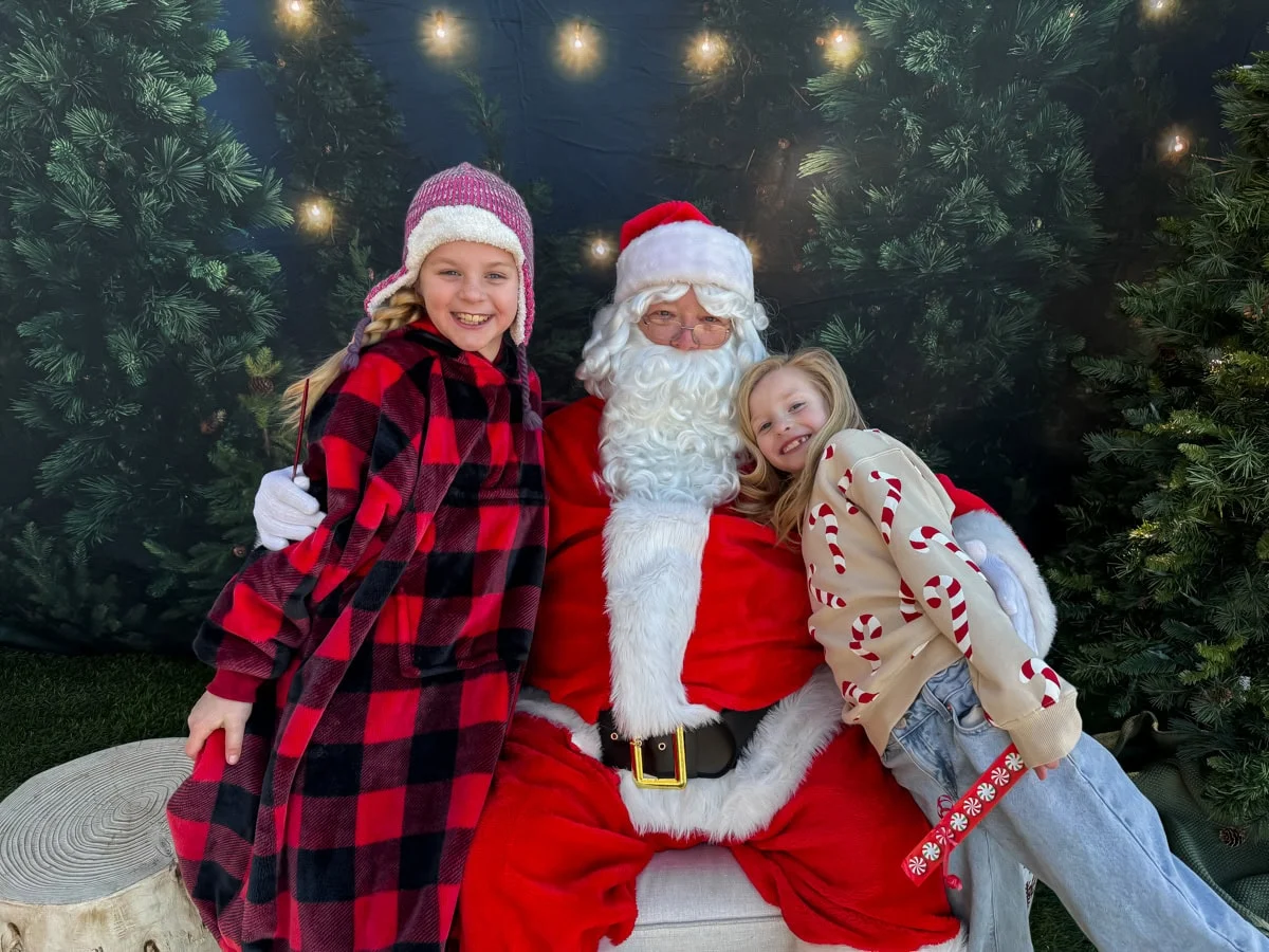 Girls taking a picture with Santa.
