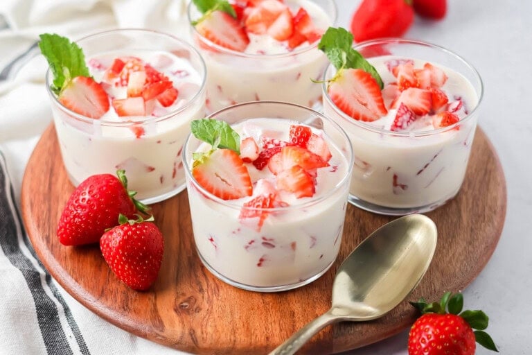 Easy Frescas con Crema served in individual cups topped with fresh strawberries.