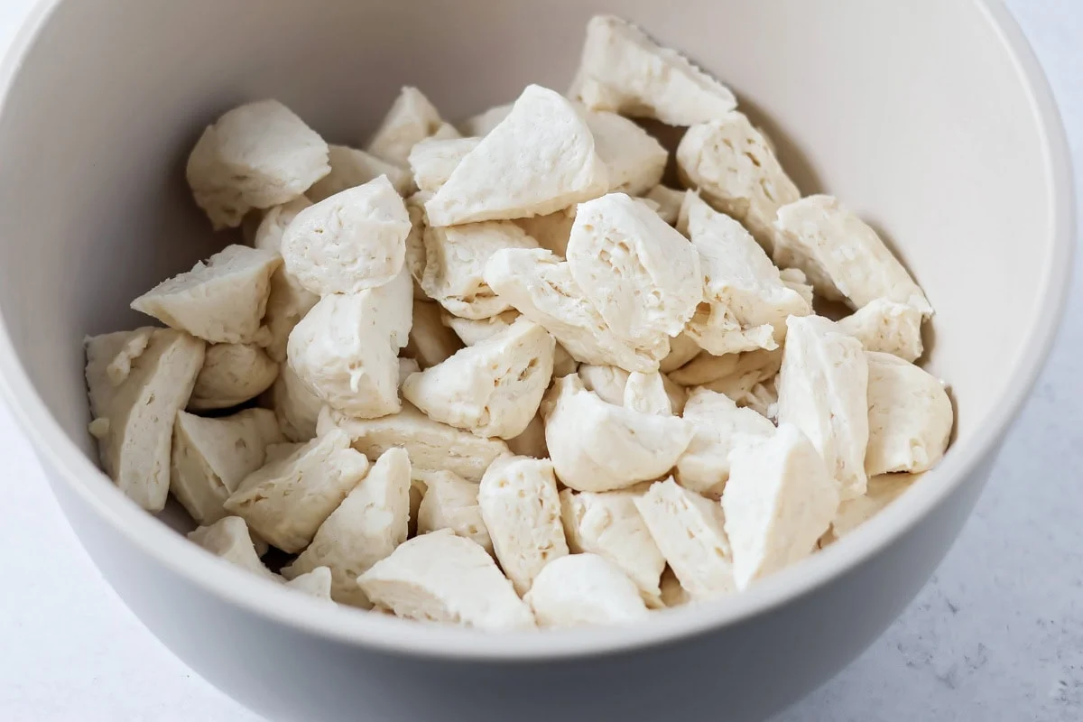 Biscuit pieces cut and placed in mixing bowl.