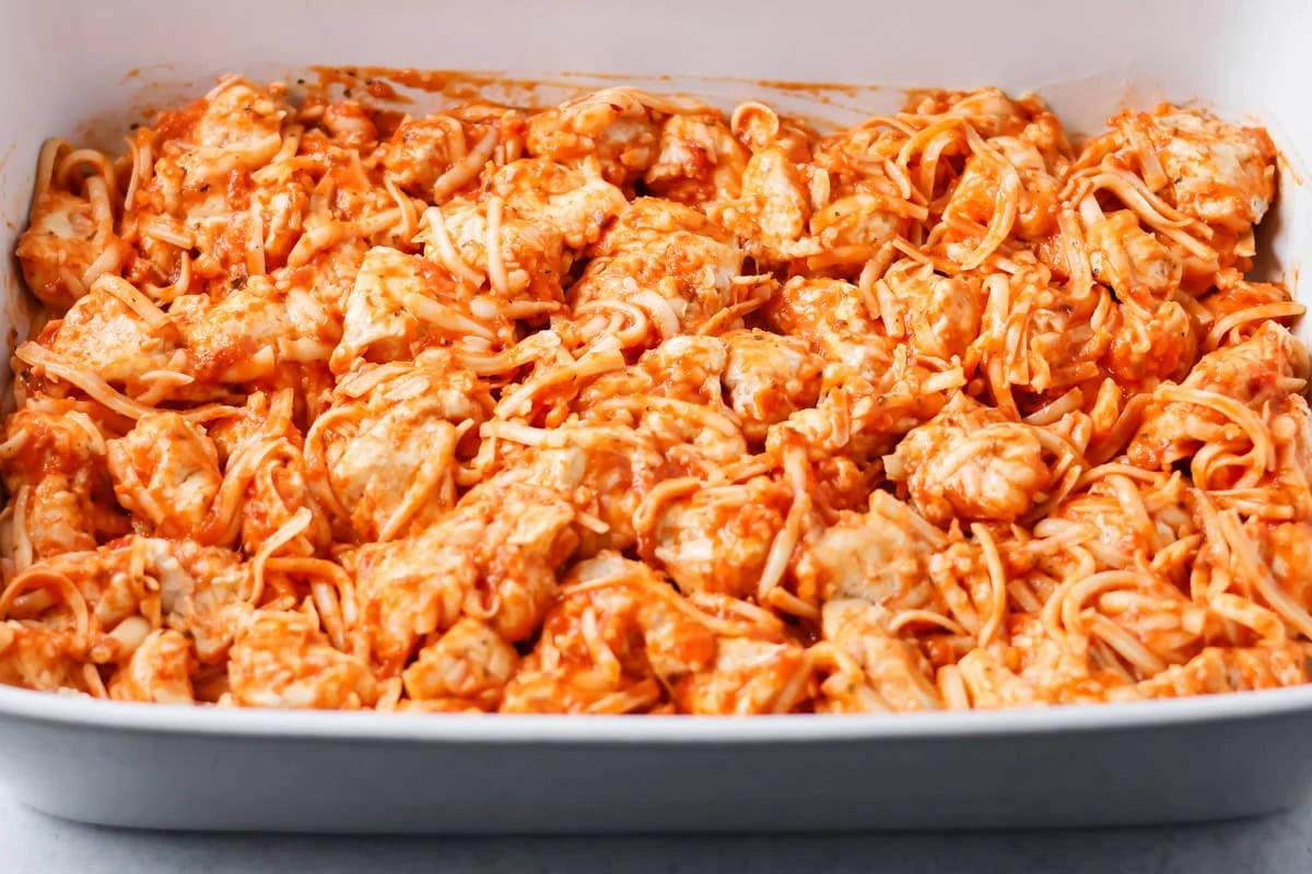 Ingredients for pizza casserole poured into baking dish.