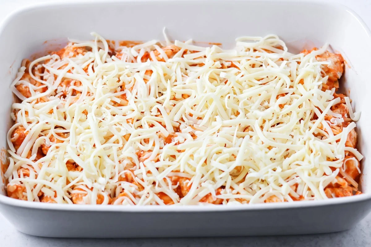 Pizza casserole in baking dish with cheese on top.