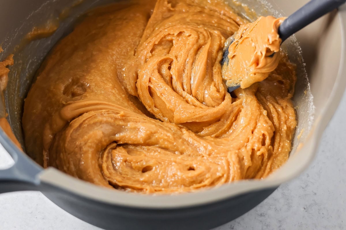 These scotcharoo cookies with crispy cereal, peanut butter, and a chocolate butterscotch topping are perfect for parties and evenings at home. Combining sugar, peanut butter, and corn syrup in a pot.