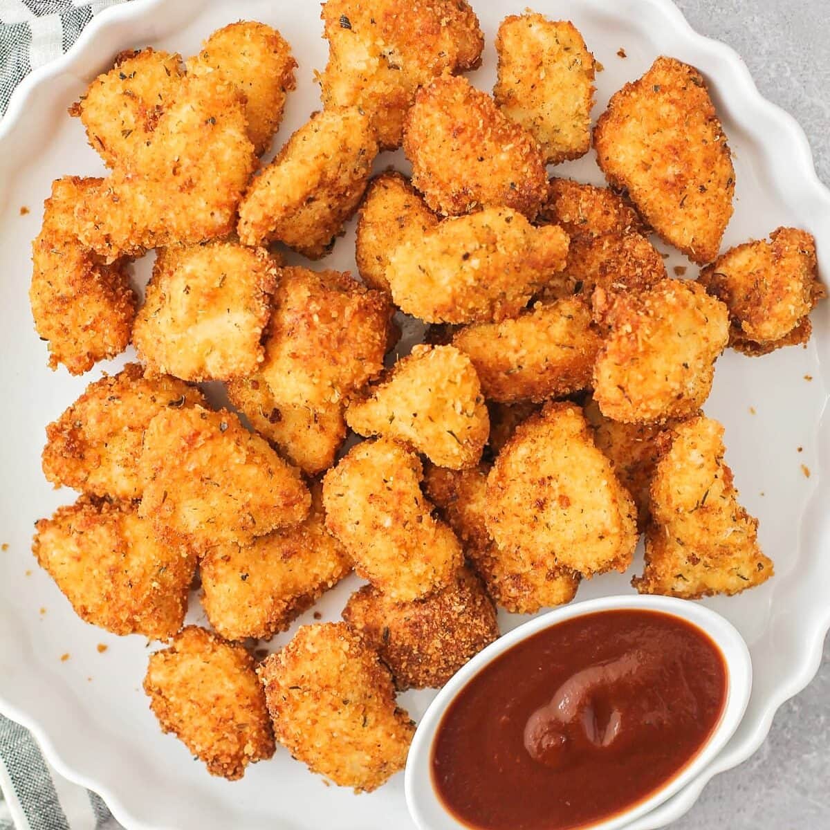 Homemade chicken nuggets with dipping sauce.