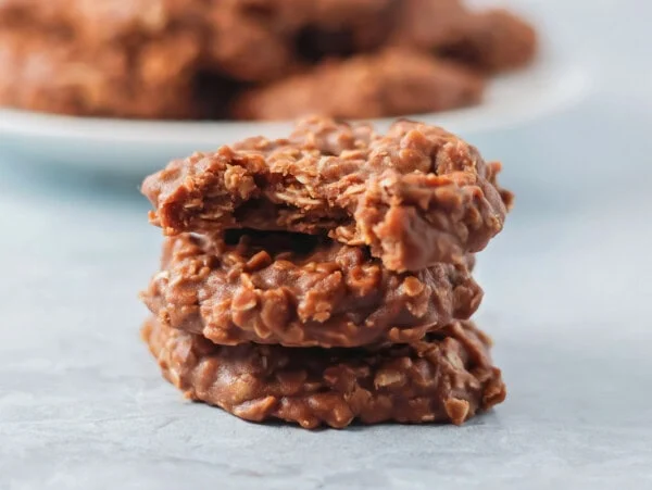 No bake cookies stacked on each other on white counter.