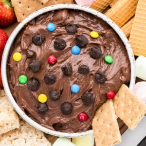 Brownie batter dip recipe in bowl with dippers all around;.
