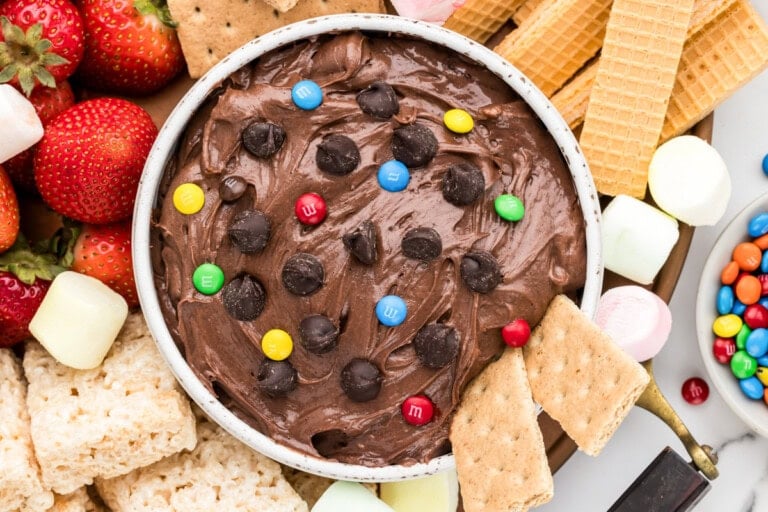 Brownie batter dip recipe in bowl with dippers all around;.