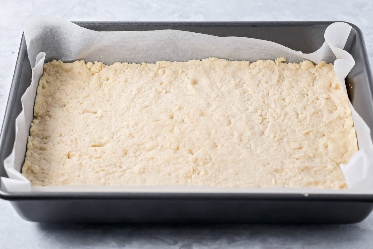 Baked crust pressed in a lined baking dish.