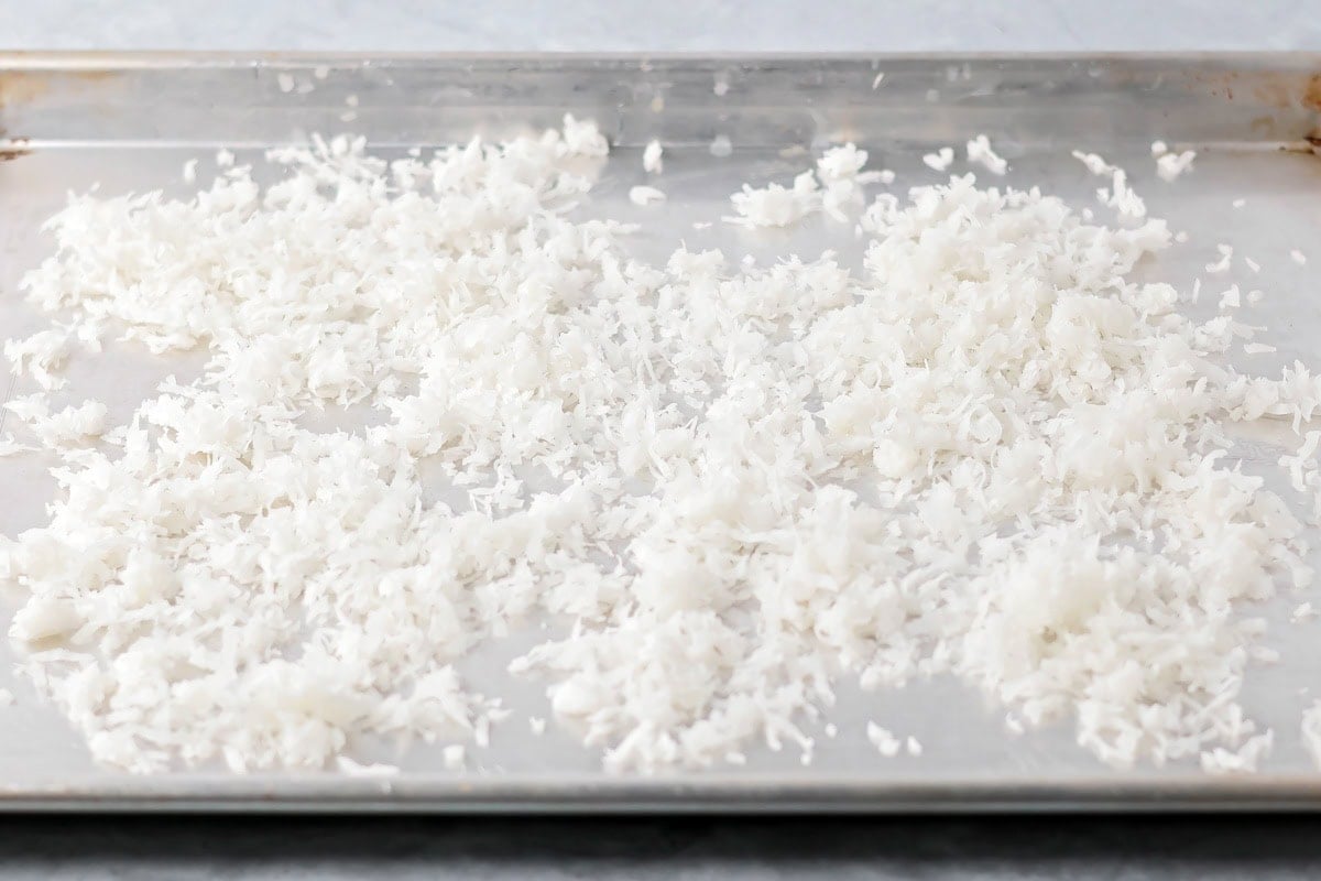Shredded coconut on a baking pan.