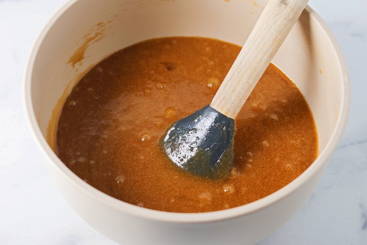 Melted butter and sugar in a mixing bowl.