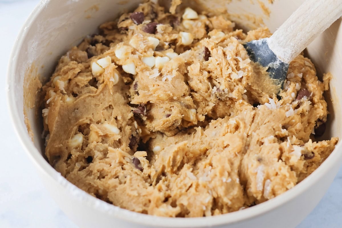 Mixing cookie dough for congo bars in a bowl.
