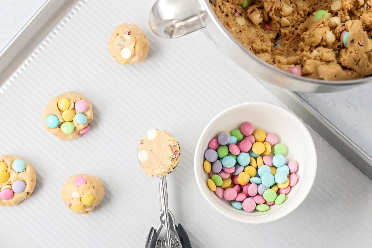 Easter cookies being scooped onto cookie tray.
