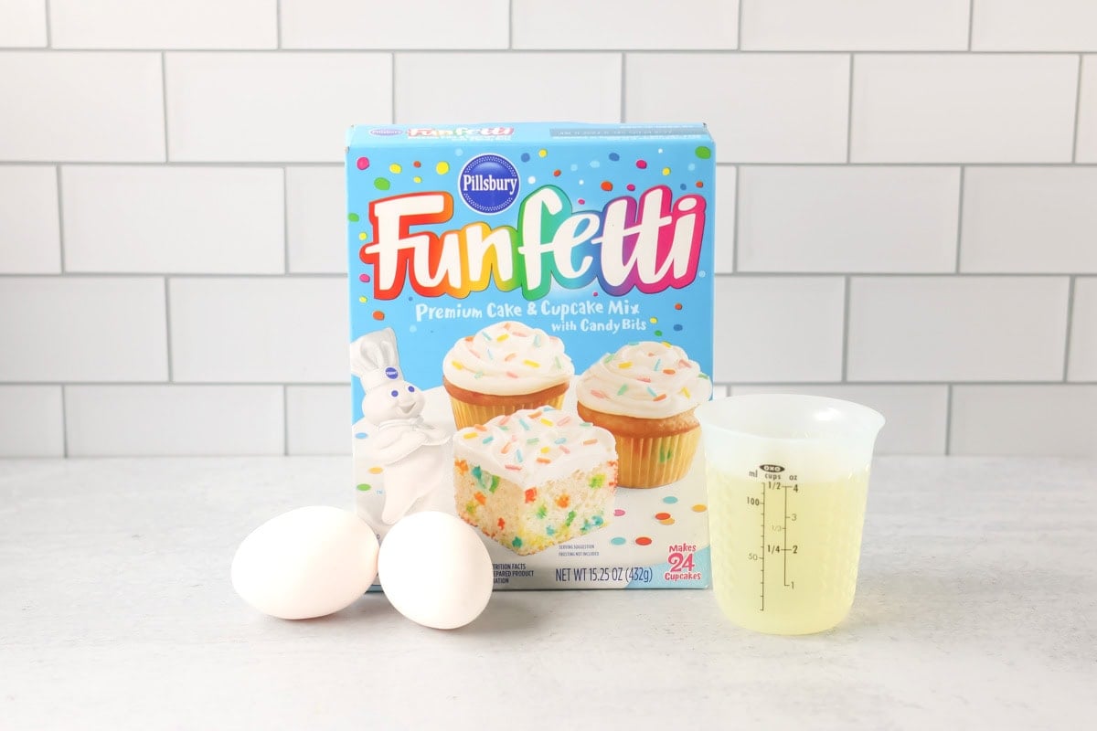 Funfetti cake mix cookies ingredients on counter.