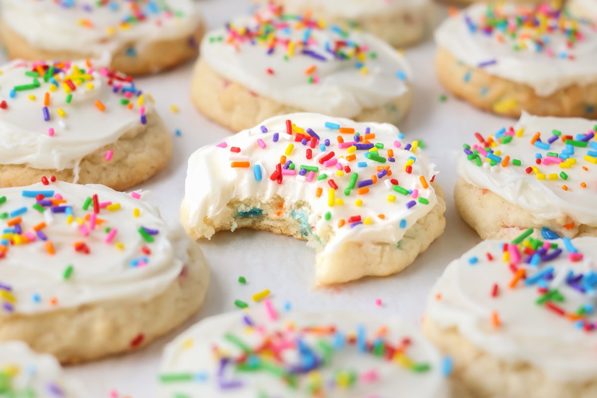 Funfetti Cake Mix Cookies with sprinkles all around and bite taken out.