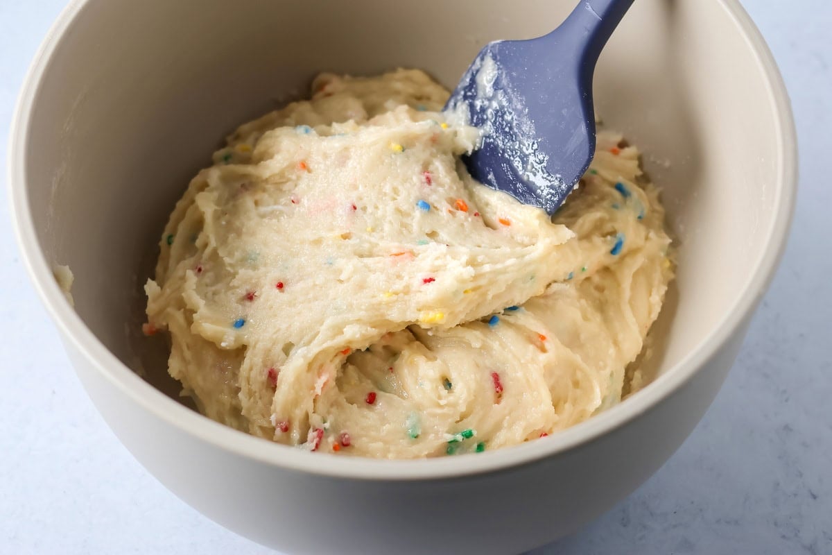 Funfetti Cake mix cookie dough in mixing bowl.