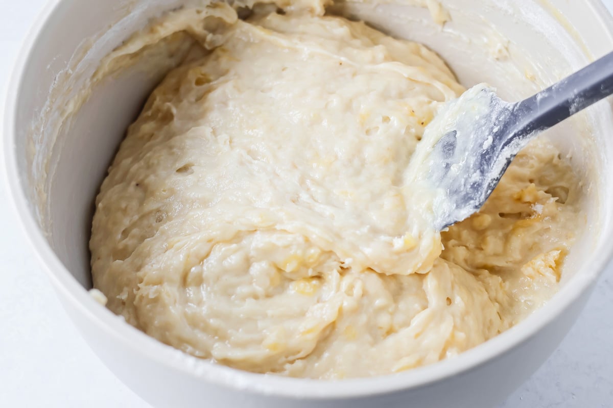 Mini banana muffins batter mixed together in bowl.