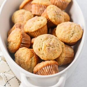 Mini Banana Muffins topped with cinnamon and sugar and in a large white dish.