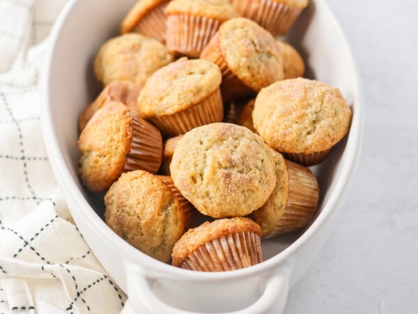 Mini Banana Muffins topped with cinnamon and sugar and in a large white dish.