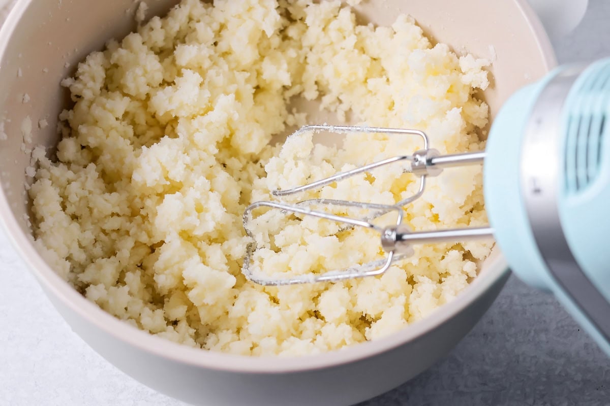Sugar and butter beat together in bowl.
