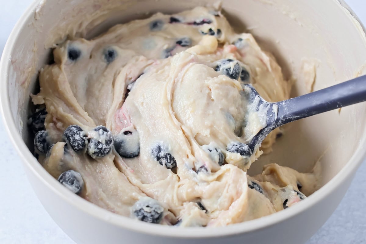 Mini blueberry muffins batter in mediume bowl.