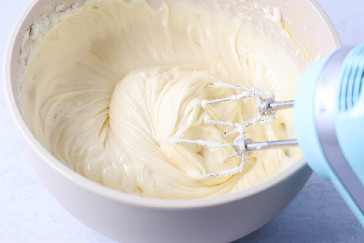 Cheesecake filling being mixed in bowl.