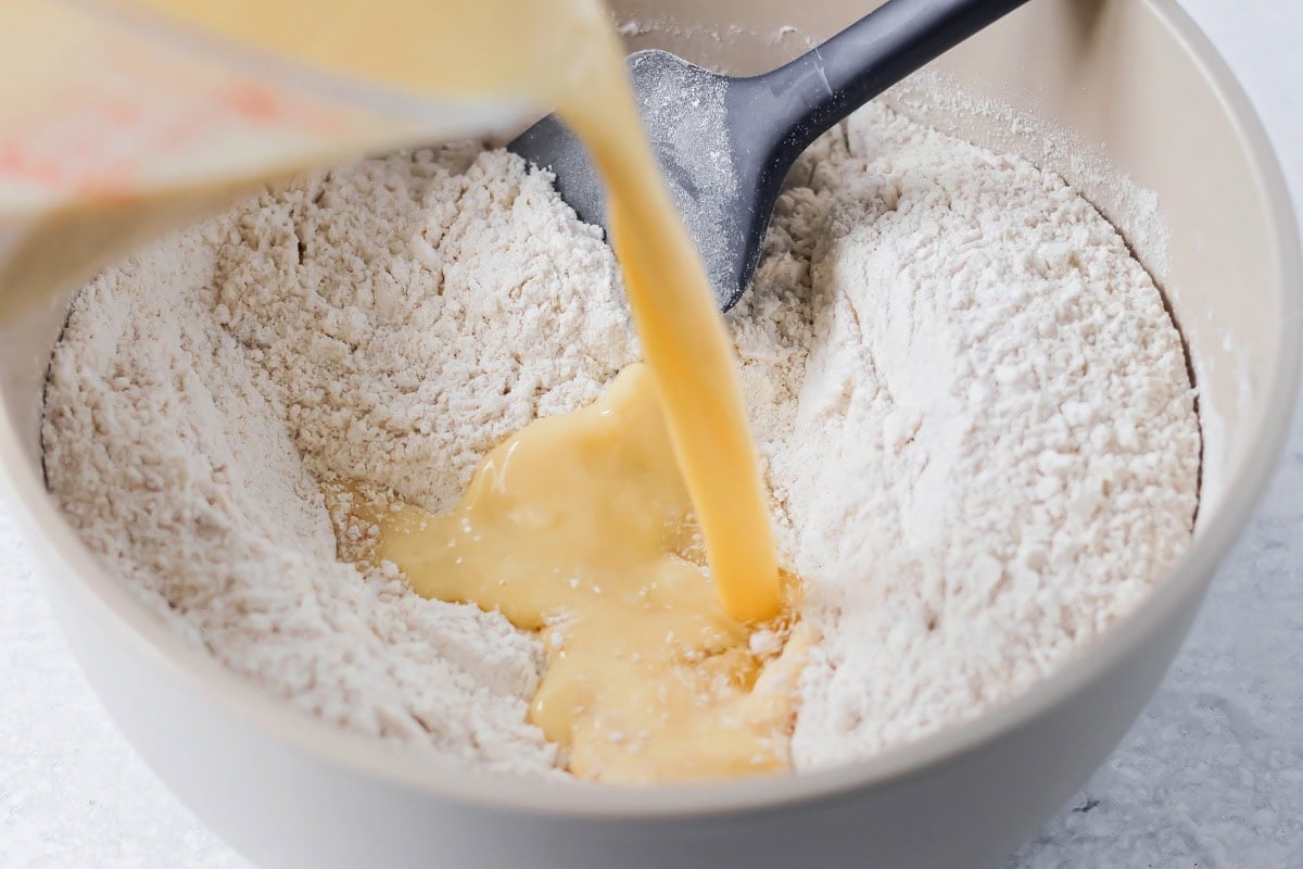 Mixing wet and dry ingredients together in bowl.