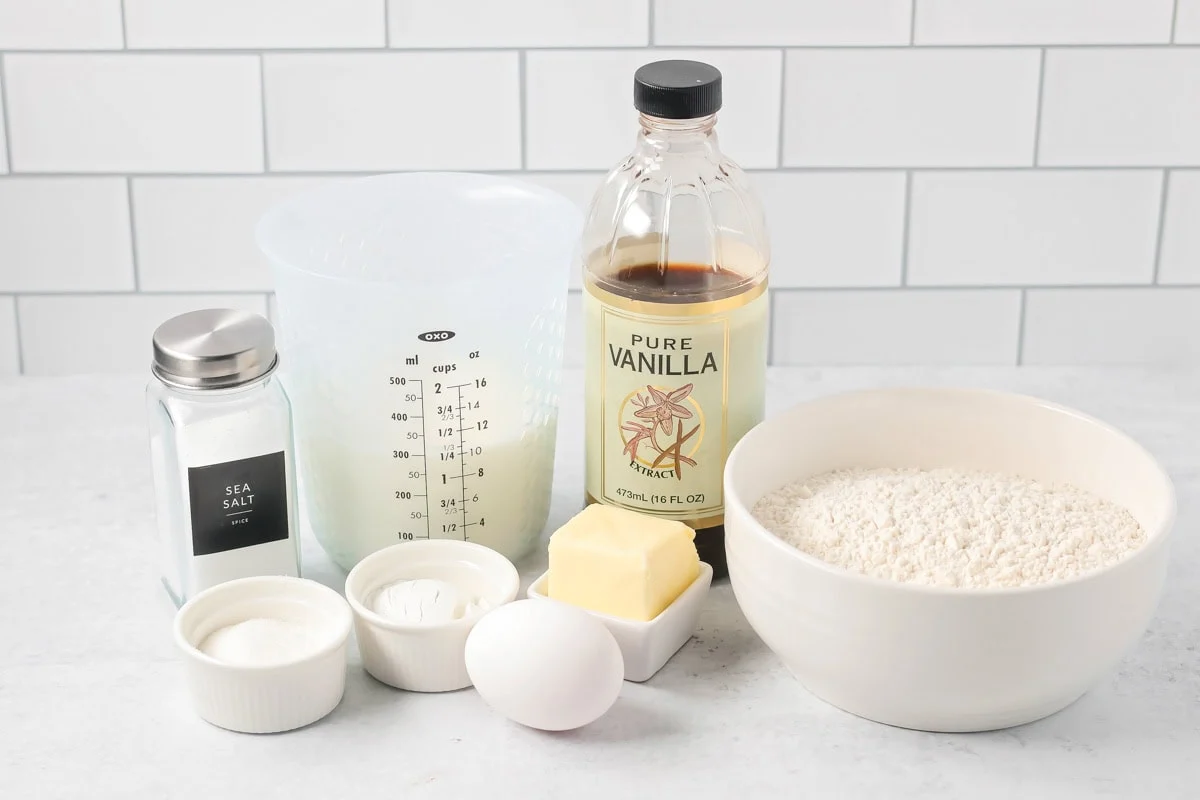 Easy pancake recipe ingredients on white countertop.