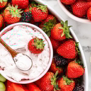 Strawberry fruit dip recipe in bowl with fruit all around.