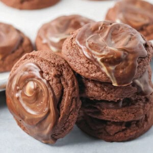 Andes mint cookies stacked on a white counter.