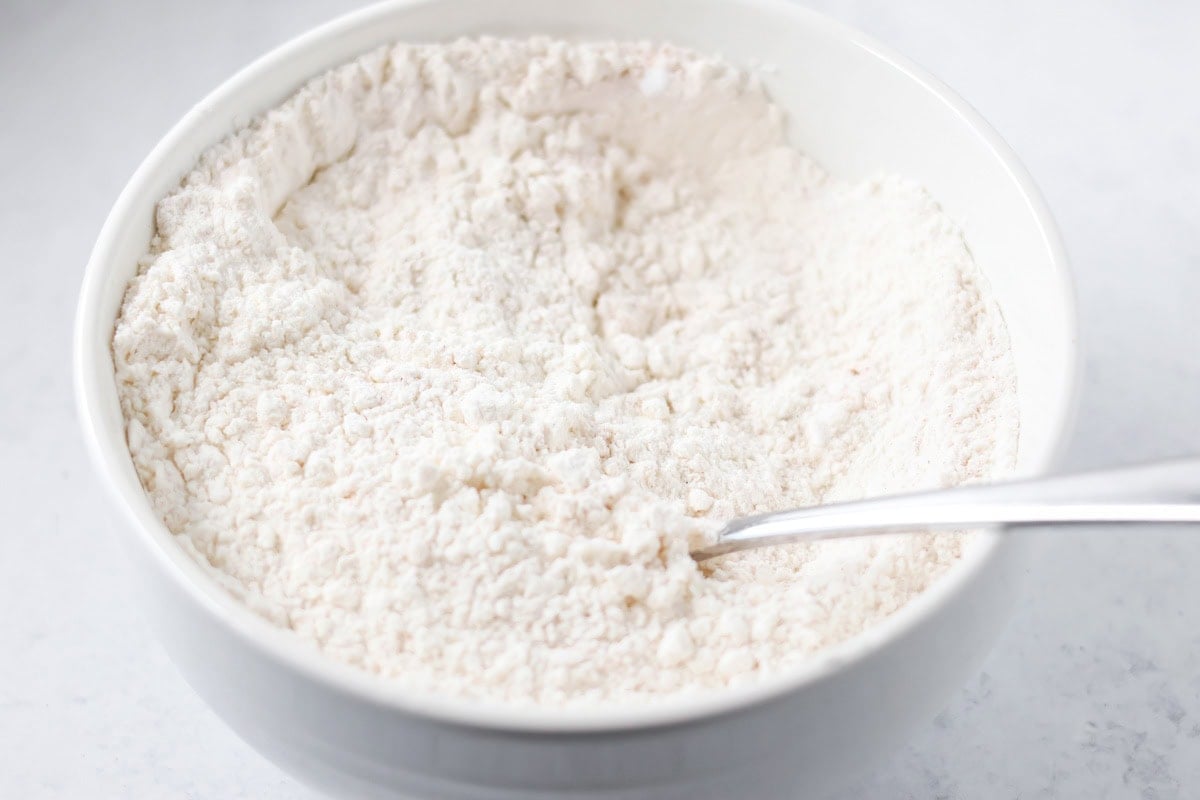 Flour and dry ingredients in a white bowl.