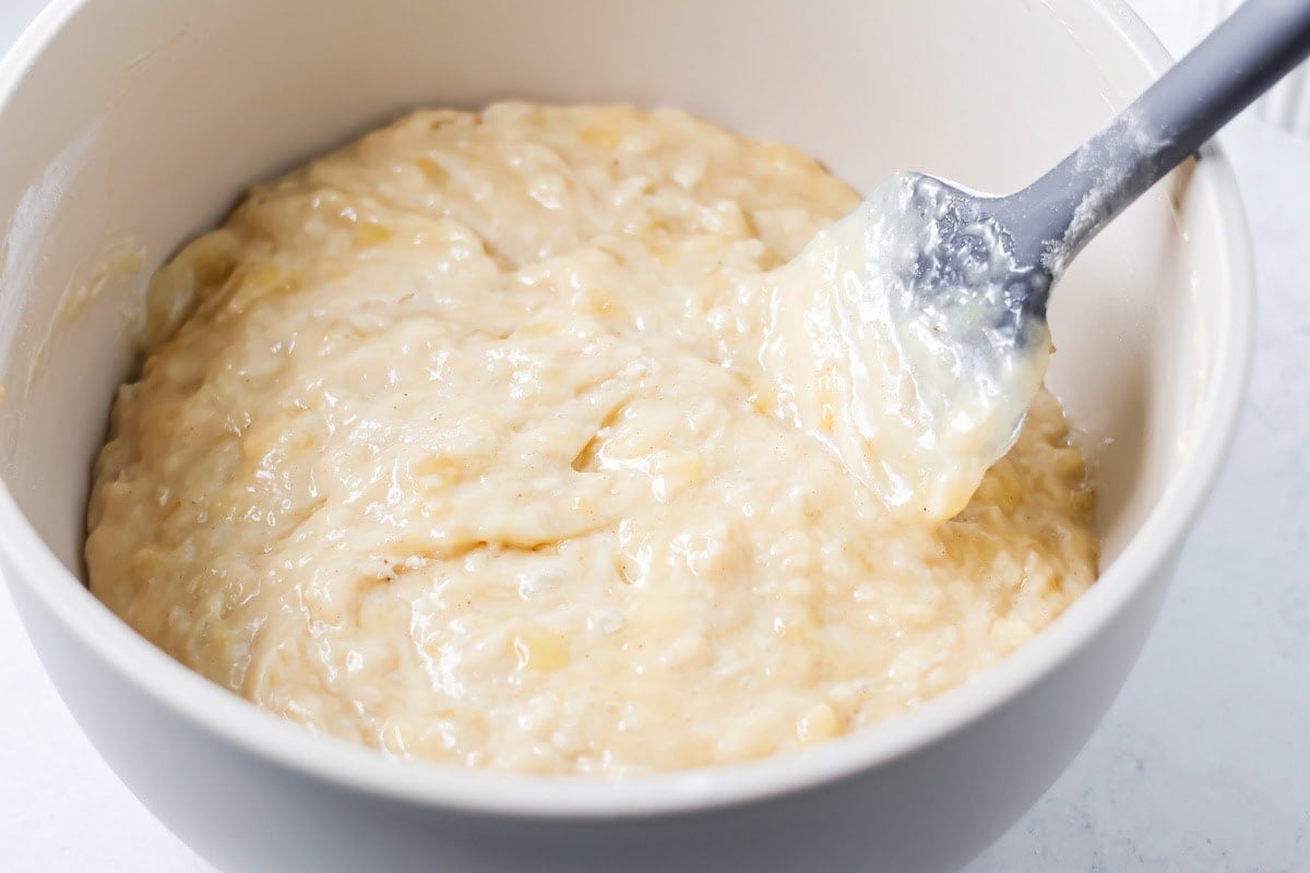 Banana muffin batter in a white bowl.