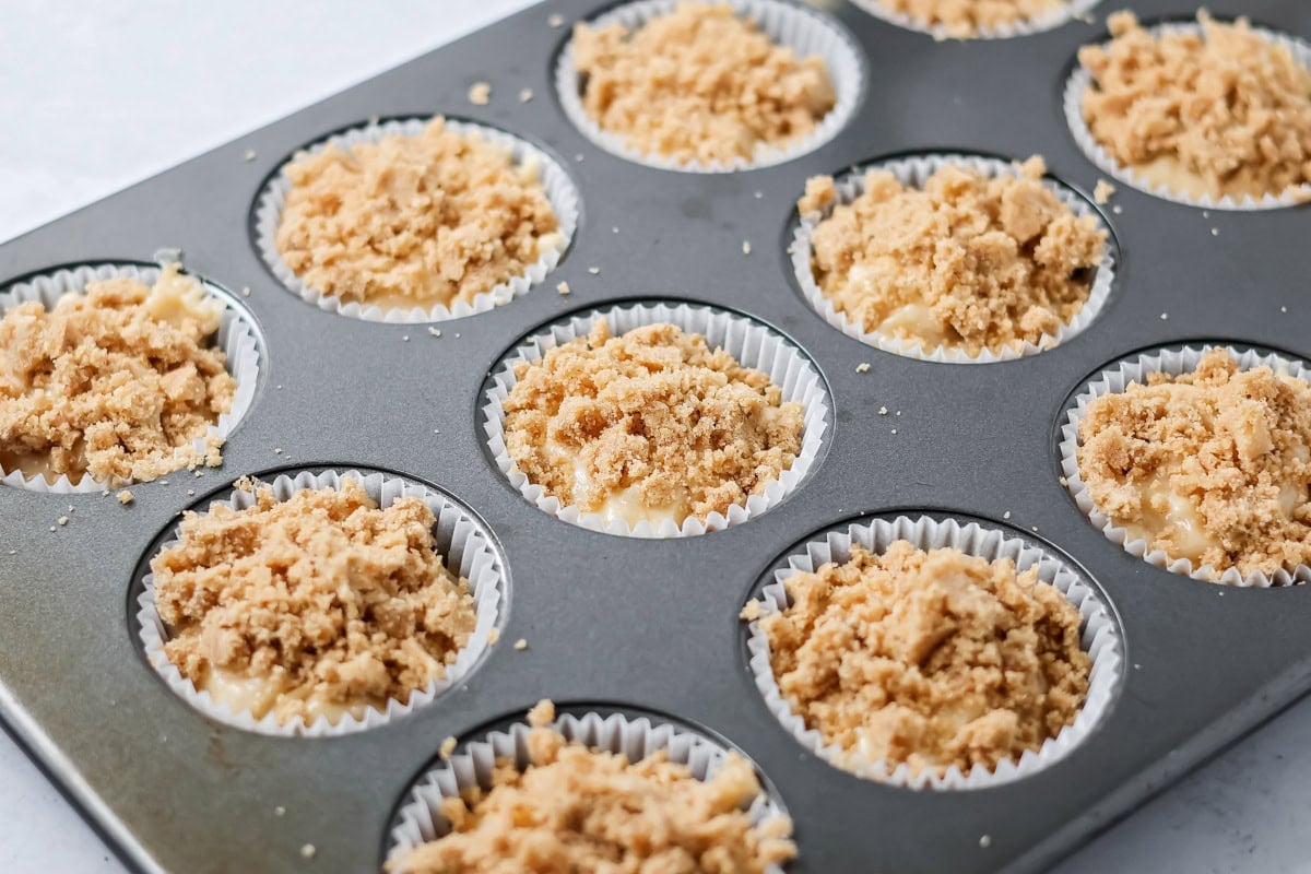 Banana crumb muffins in a tin ready to bake.