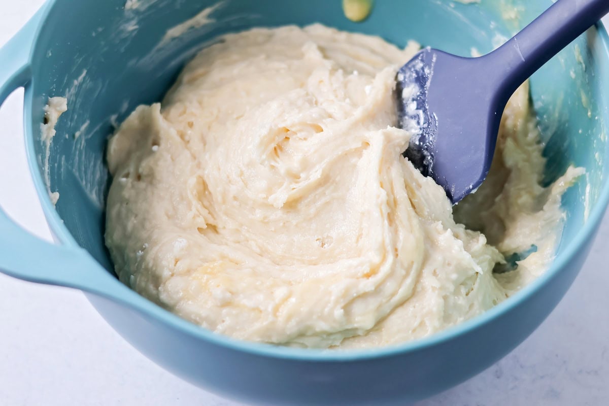 Mixing batter for bisquick strawberry shortcakes.
