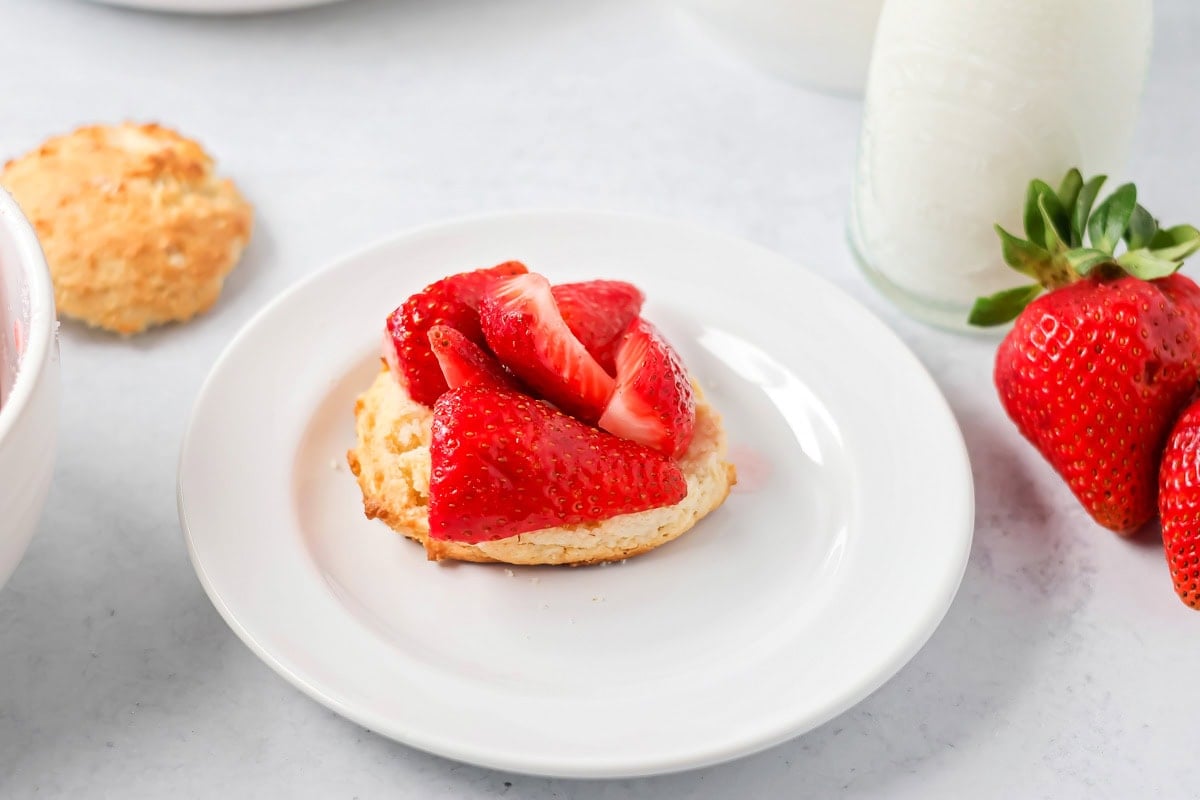 Adding strawberries to the bisquick layer.